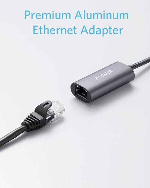 Anker PowerExpand USB-C to Gigabit Ethernet Adapter connected to a laptop, showing compact design and Ethernet port.