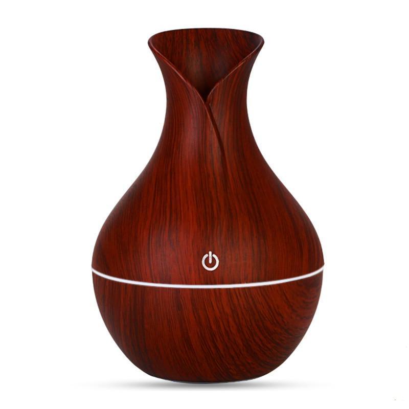 Wood grain vase-shaped Stevvex essential oil diffuser with 7 LED colors and waterless auto shut-off, ideal for home and office use.