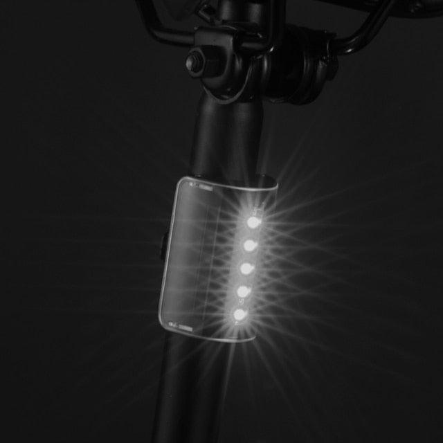 Stevvex waterproof auto-sensing bicycle rear light with LED modes, USB rechargeable, designed for night riding safety and visibility.