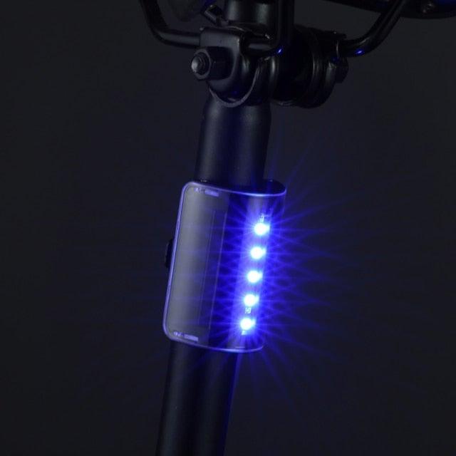 Stevvex ST90SP4158YIO waterproof auto-sensing bicycle tail light with LED, USB rechargeable, mounted on bike saddle for night safety.
