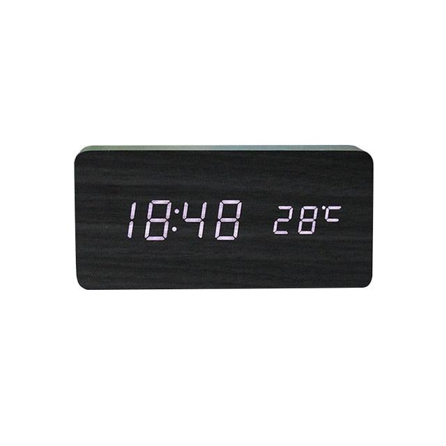 Stevvex USB/AAA powered wooden LED digital alarm clock with wireless charging, multiple alarms, sound control, and snooze feature.