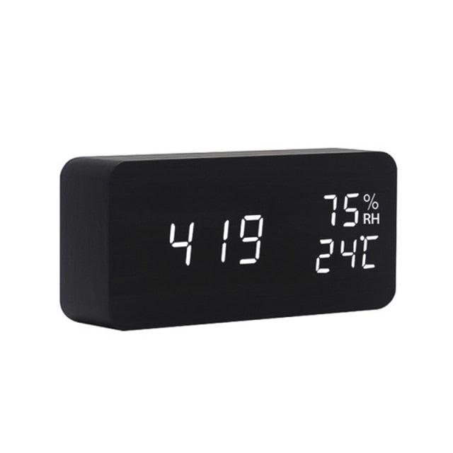 Stevvex USB/AAA powered wooden digital alarm clock with LED display, wireless charging, sound control, snooze, and multiple alarms.