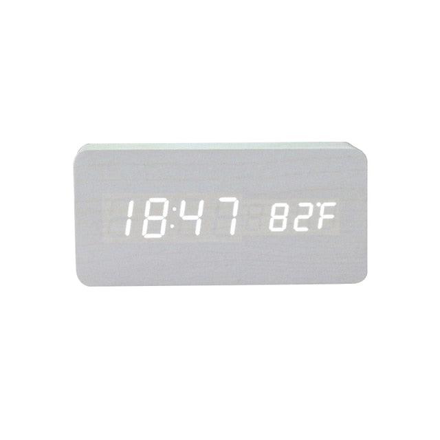 Stevvex wooden digital alarm clock with LED display, wireless charging, triple alarms, sound control, snooze, and voice activation.